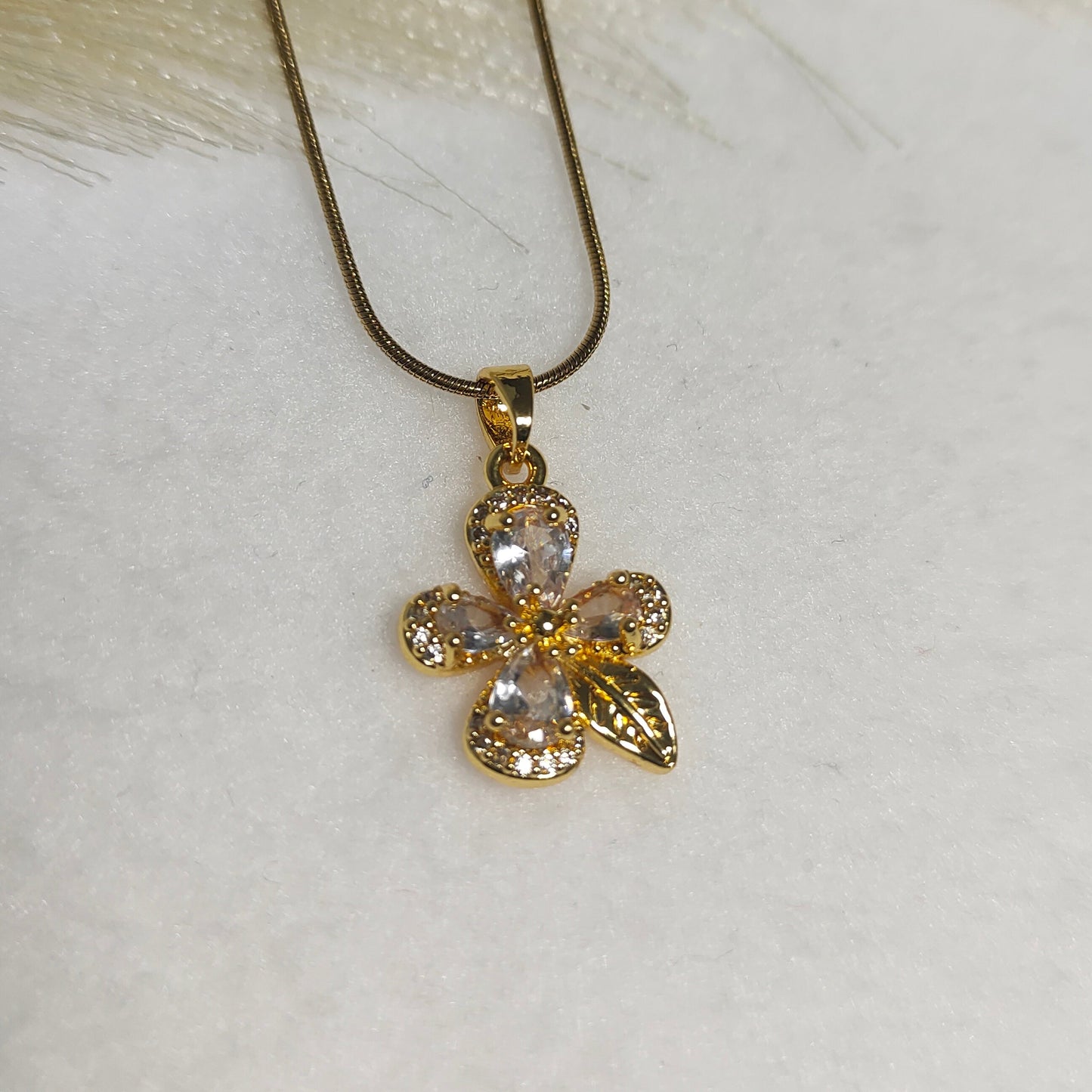 Gold framed white flower pendant necklace