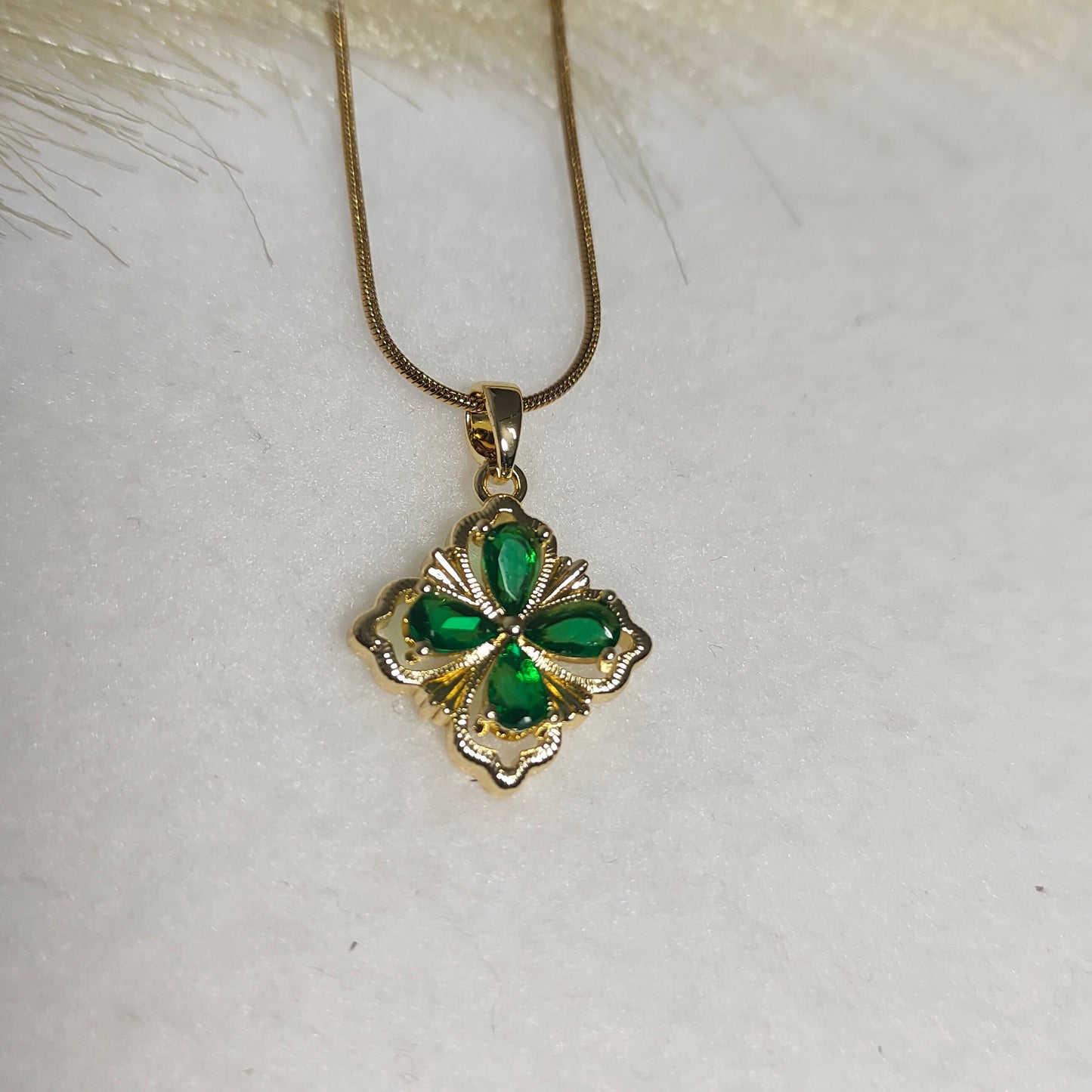 Gold framed emarald pendant necklace